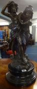 A large sculpture of two children with bronze finish on heavy black marble socle base, signed August
