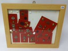 A framed collection of Military badges and buttons of various Regiments, frame size 48cm x 58xm (