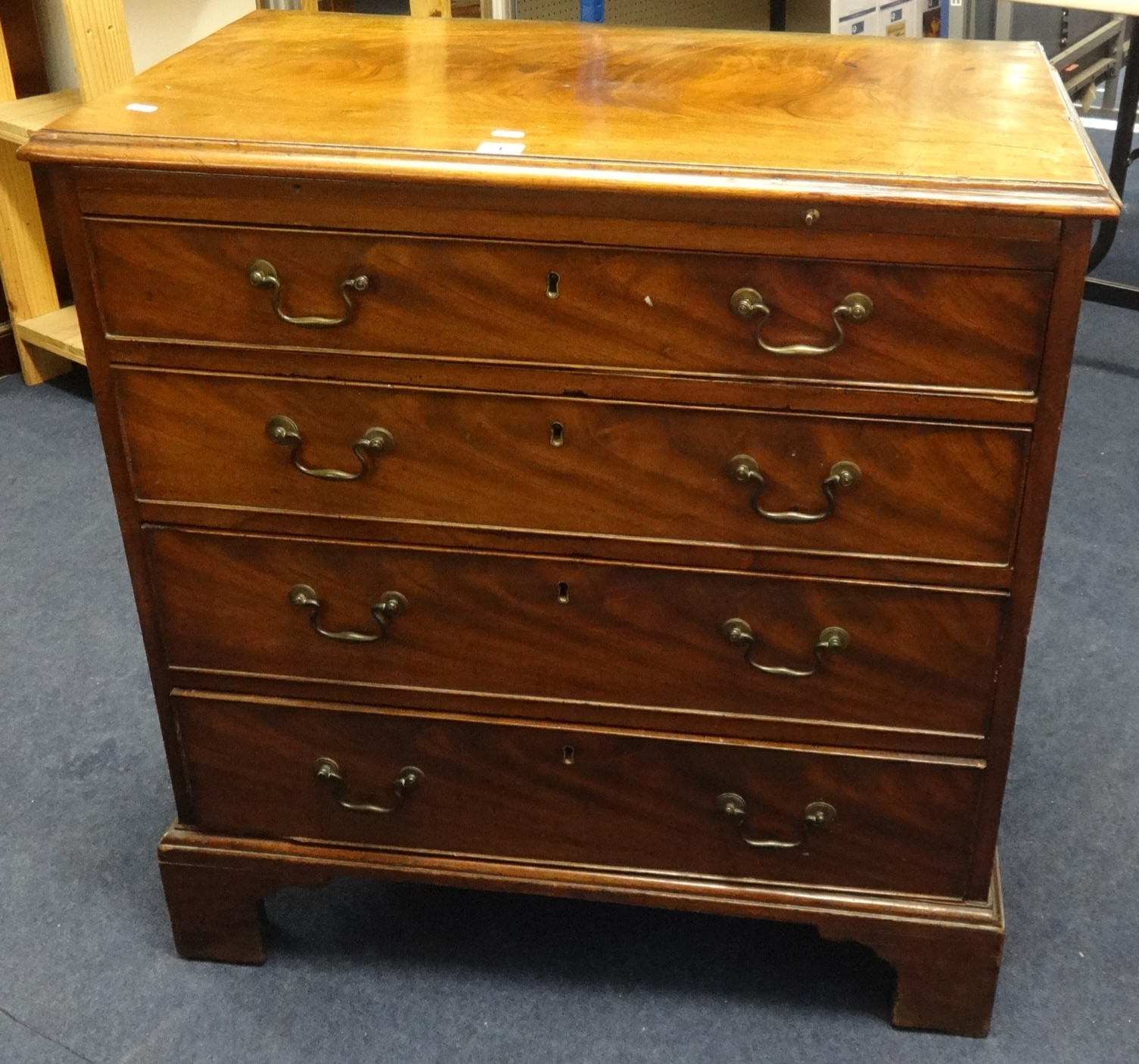 A 19th Century mahogany bachelors chest of drawers, fitted with a brushing slide over four long