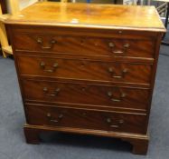 A 19th Century mahogany bachelors chest of drawers, fitted with a brushing slide over four long