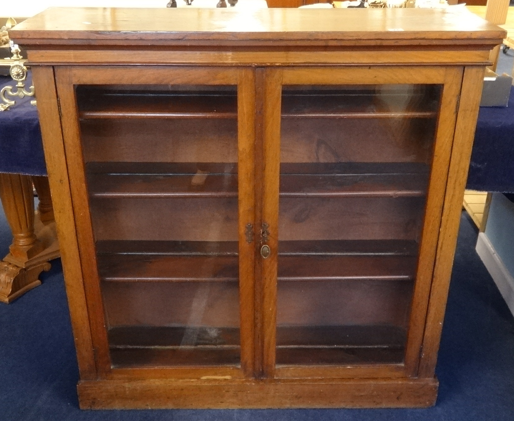 A late Victorian walnut two door glazed bookcase, width 107cm, height 108cm.