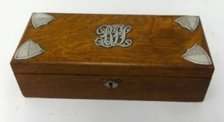 An oak box, with silver shield mounts, length 30cm.