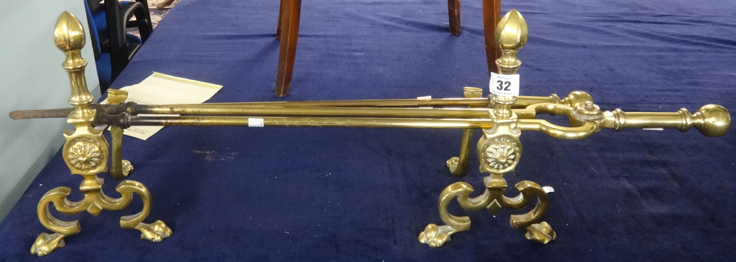 A 19th century pair of heavy brass fire irons and similar 'andirons'.