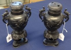 A pair of Oriental bronze urns with covers, height 25cm.