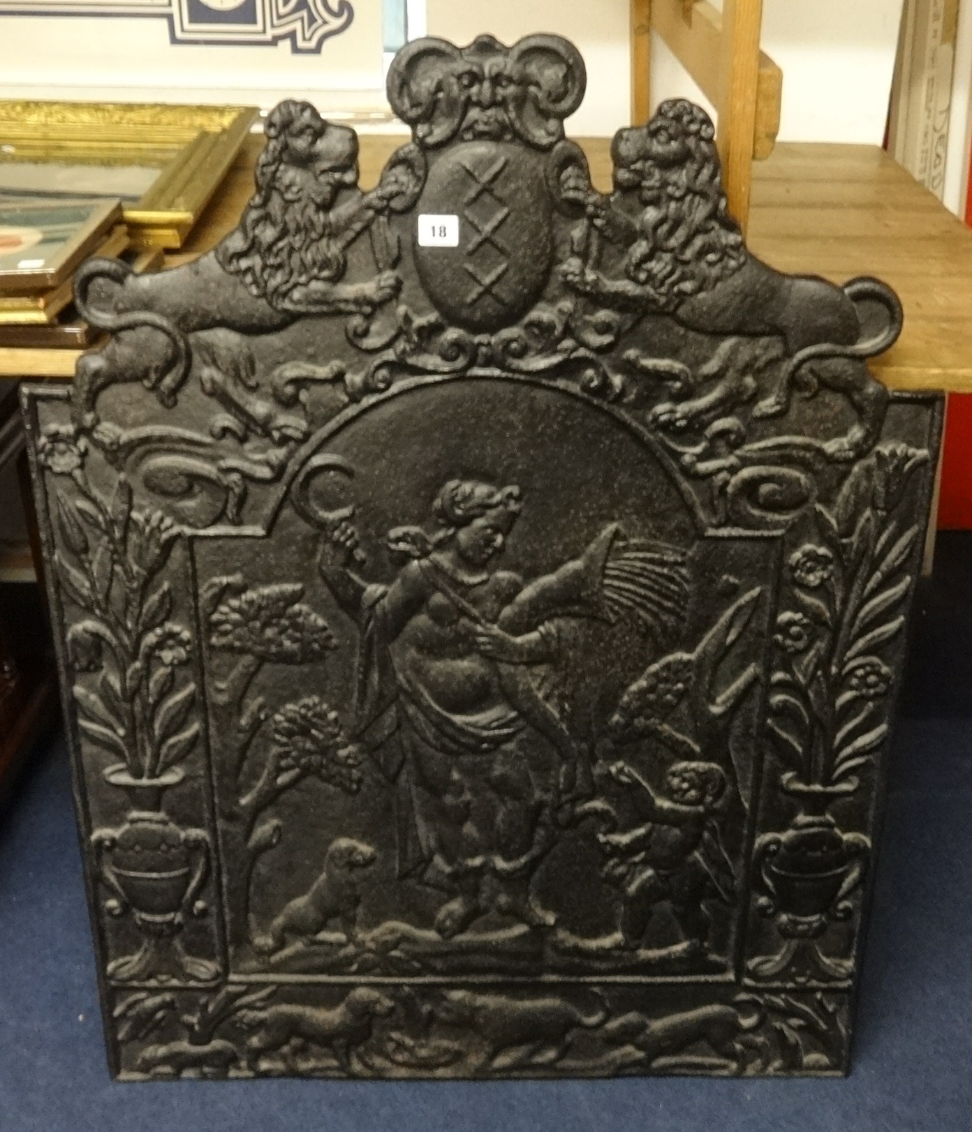 An antique heavy cast Iron fireback decorated with Lions, figures and animals, height approx