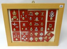 A framed collection of Military badges and buttons, mainly modern, frame size 48cm x 58cm (approx