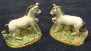 A pair of Staffordshire models, white horses, height 12cm.