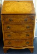 A reproduction burr walnut bureau, fitted with four serpentine drawers, width 54cm.