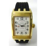 A Jaeger LeCoultre, a gents 18ct gold Reverso Grand Sport wristwatch, with black leather bracelet