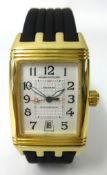 A Jaeger LeCoultre, a gents 18ct gold Reverso Grand Sport wristwatch, with black leather bracelet