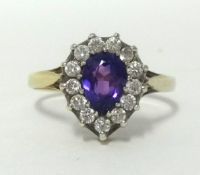 A 9ct amethyst and diamond cluster ring, finger size O/P.