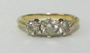 A 9ct gold and three stone diamond ring, total diamond weight approx 0.76cts together with 2007