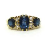 A sapphire and diamond set ring comprising of three sapphires and six small round cut diamonds, in