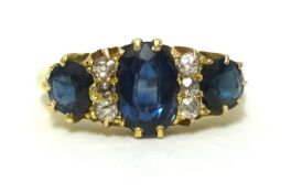 A sapphire and diamond set ring comprising of three sapphires and six small round cut diamonds, in