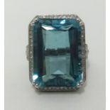 A 14k white gold and diamond ring set with a large emerald cut aqua marine, approx 24cts, diamonds