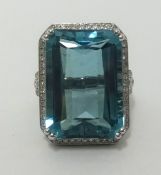 A 14k white gold and diamond ring set with a large emerald cut aqua marine, approx 24cts, diamonds