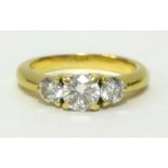 A 18ct three stone diamond set ring, the centre stone approx 0.30cts, finger size L.