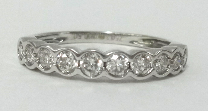 A 18ct white gold diamond set half band eternity ring, finger size L.