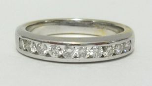 A diamond channel set half band eternity ring, set with 11 stones, no hallmark, finger size P.