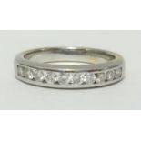 A diamond channel set half band eternity ring, set with 11 stones, no hallmark, finger size P.