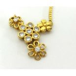 Diamond set pendant of flower design in yellow metal, the chain stamped 750