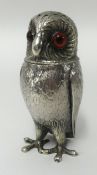 A Silver pepperette modelled as an Owl, with glass eyes maker H.W and Co, height 10cm.
