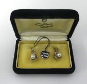 Mikimoto, a pair of pearl and silver earrings of leaf design in original box, Hong Kong.