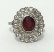 A ruby and diamond cluster ring, set in probably platinum overall size 15mm x 16mm, finger size M.