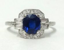 An Art Deco platinum, sapphire and diamond cluster ring set with an arrangement of baguette and
