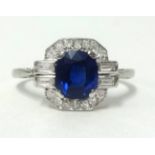 An Art Deco platinum, sapphire and diamond cluster ring set with an arrangement of baguette and