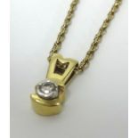 Single diamond pendant set in gold stamped 585 on a 9ct gold chain