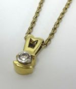 Single diamond pendant set in gold stamped 585 on a 9ct gold chain