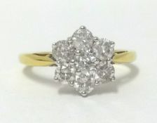 An 18ct diamond cluster ring, comprising seven round cut diamonds, finger size O.