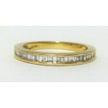 A 18ct half band eternity ring, set with baguette cut diamonds, finger size K/L.