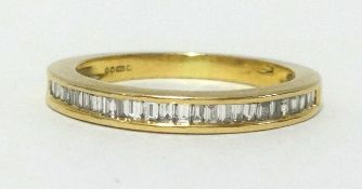 A 18ct half band eternity ring, set with baguette cut diamonds, finger size K/L.