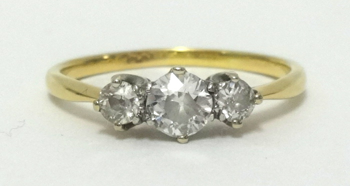 A 18ct diamond three stone ring, finger size S.