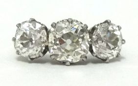 A fine antique diamond three stone ring set in platinum, the old cut diamonds approx 3.75 carats,