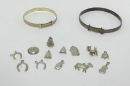 Two silver bangles and a collection of various silver charms.