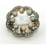 An antique 15ct gold opal and diamond set brooch, approx 23mm diameter.