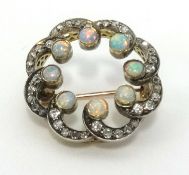 An antique 15ct gold opal and diamond set brooch, approx 23mm diameter.