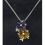 A good quality 18ct amethyst and citrine pendant of a double flower head design set with diamonds on