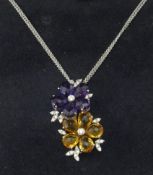 A good quality 18ct amethyst and citrine pendant of a double flower head design set with diamonds on