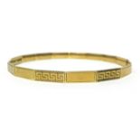 A 9ct gold slave bangle with key cut decoration, diameter approx 74mm, approx 13.60 gms.
