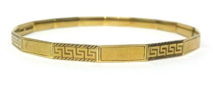 A 9ct gold slave bangle with key cut decoration, diameter approx 74mm, approx 13.60 gms.