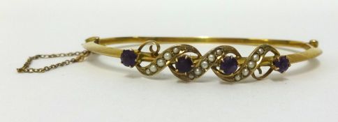A yellow metal bangle set with amethyst and seed pearl approx 5.4gms.
