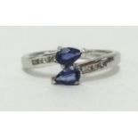 A white gold and tanzanite ring, set with diamonds to the shoulders, finger size M.