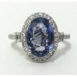 A white gold and diamond ring, set with an oval cut tanzanite, approx 3.67cts, diamond weight approx