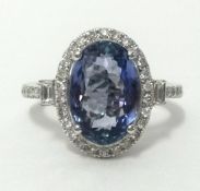 A white gold and diamond ring, set with an oval cut tanzanite, approx 3.67cts, diamond weight approx