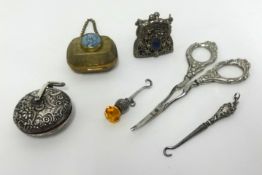 Chatelaine objects including silver pin cushion with repousse work, silver thistle button hook,