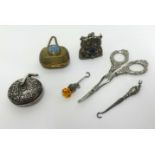 Chatelaine objects including silver pin cushion with repousse work, silver thistle button hook,